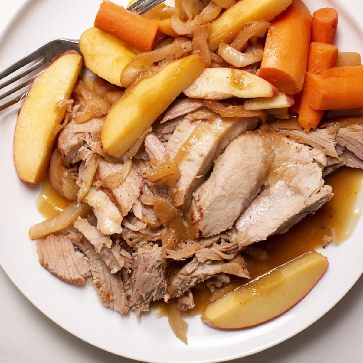 Tender and flavorful Slow Cooker Apple Cider Pork Roast garnished with fresh herbs.  