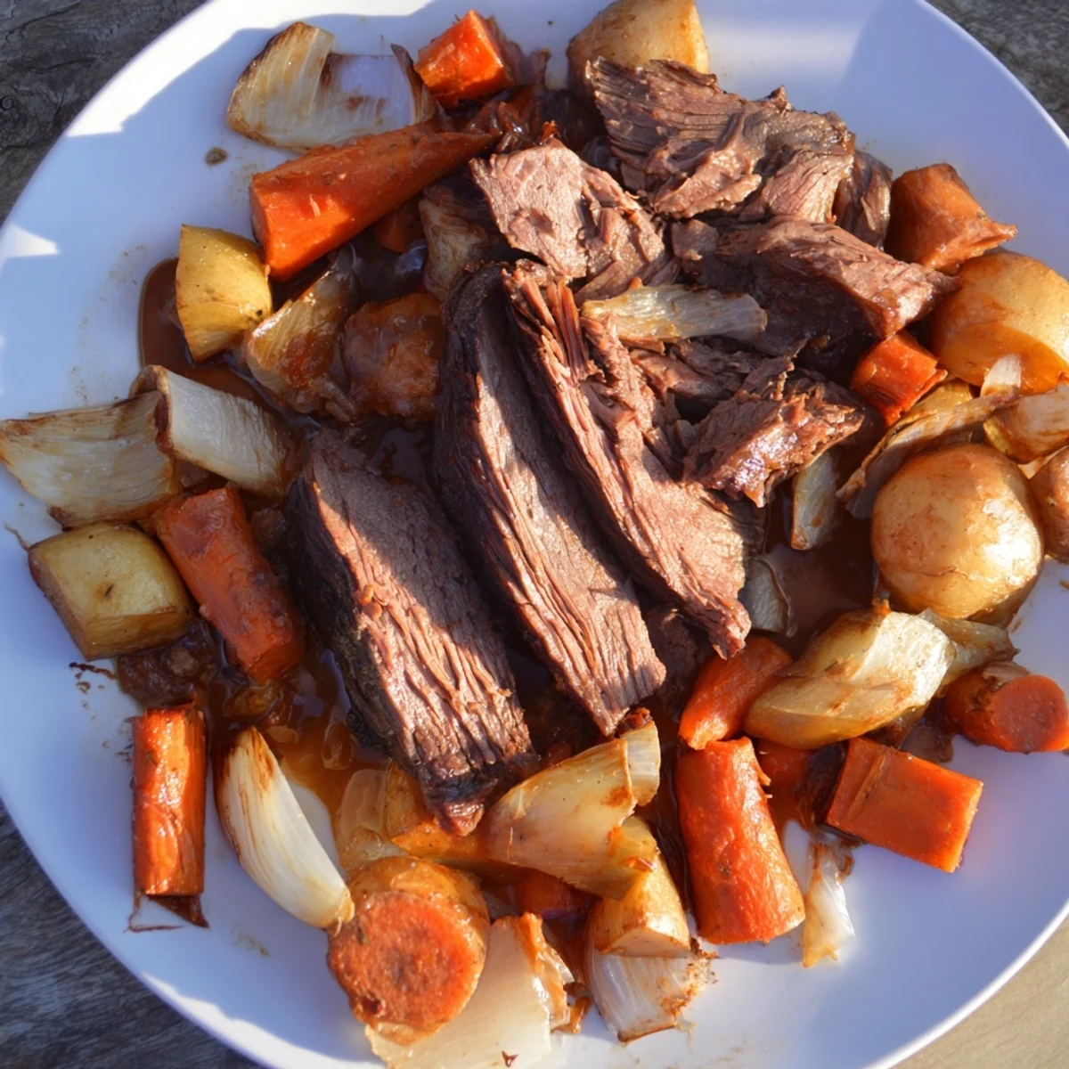Close-up of a steaming Sunday Pot Roast, showcasing juicy beef and colorful, roasted veggies.