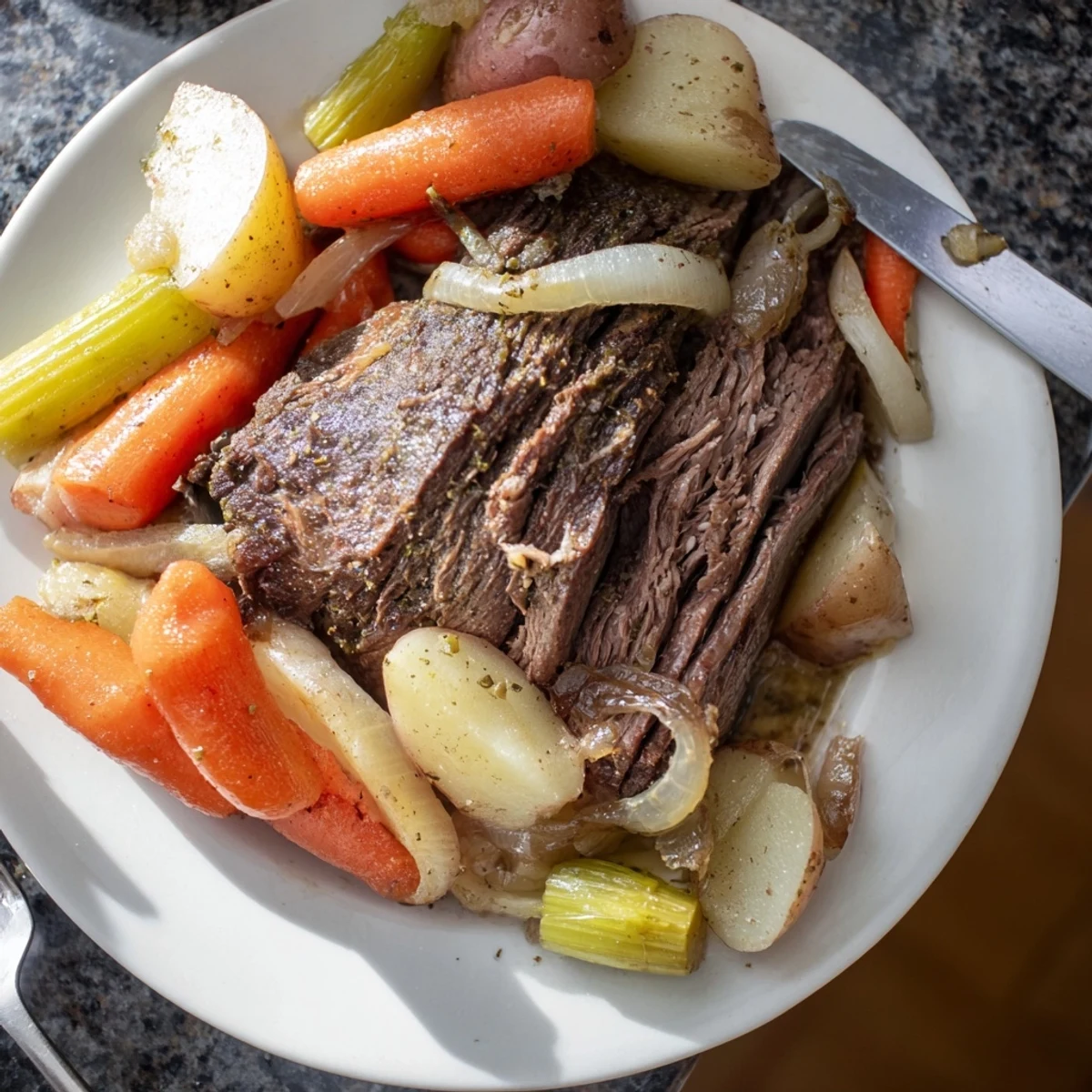 Fork-tender and delicious, this Pickle Brine Pot Roast rests amid a bed of colorful cooked vegetables.