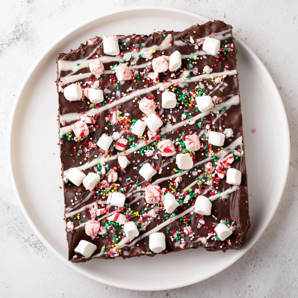 Deliciously rich Viral Hot Chocolate Bomb Bark with melted white chocolate drizzle and crushed peppermint candies, perfect for sharing.