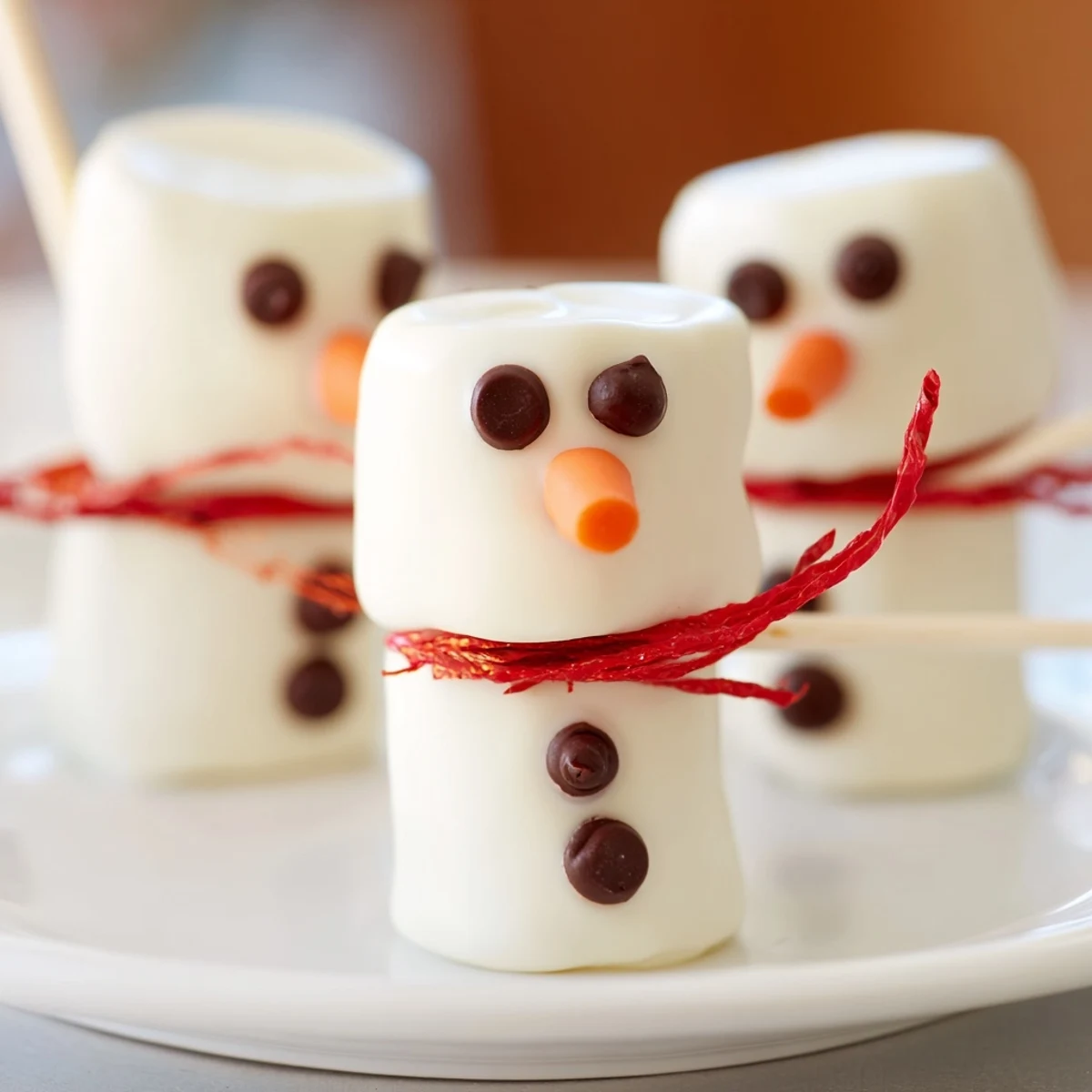 Festive Express Snowman Marshmallow Pops, adorned with dark chocolate faces and colorful scarves.