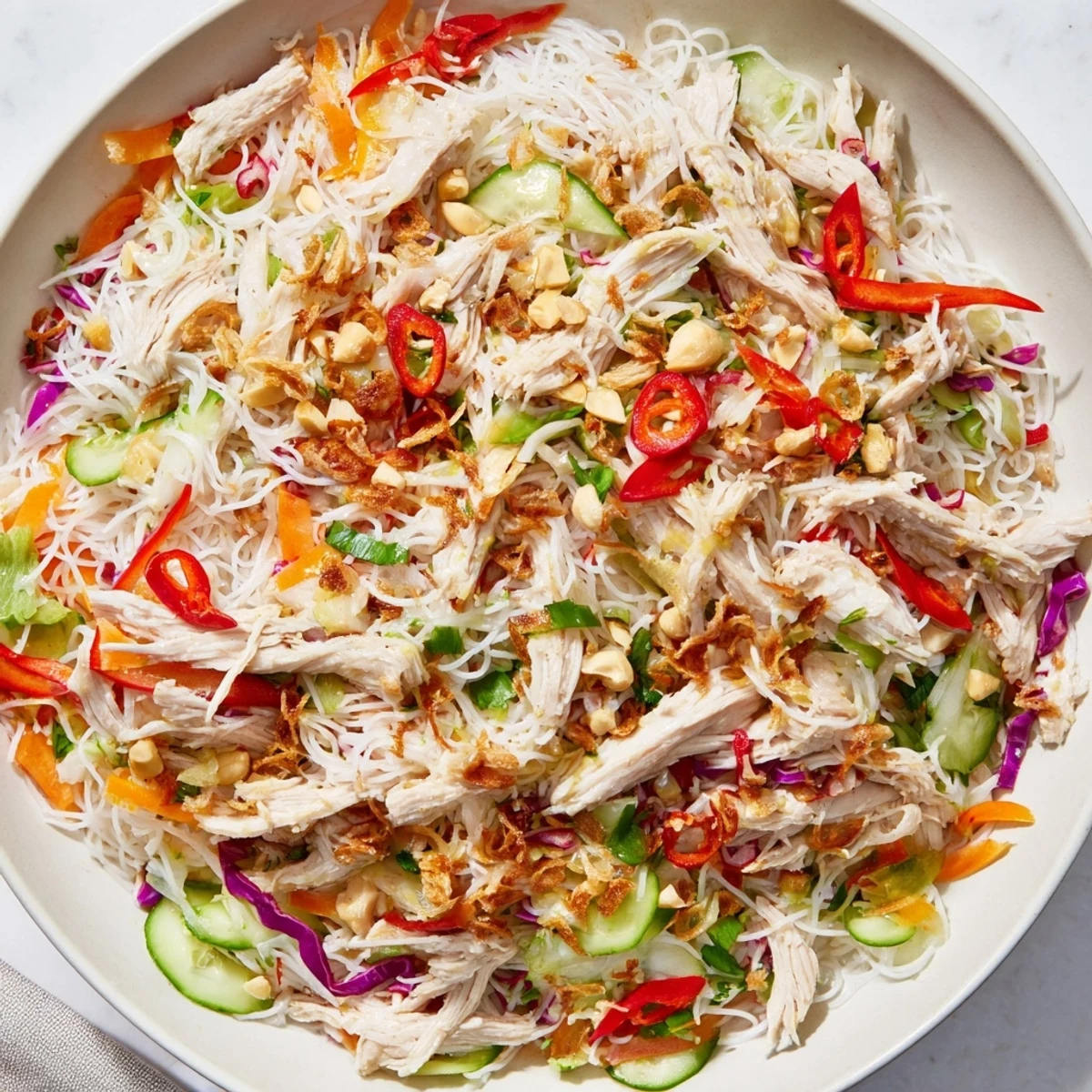 Fresh Vietnamese Crunch Noodle Salad, vibrant with shredded chicken and crunchy vegetables.
