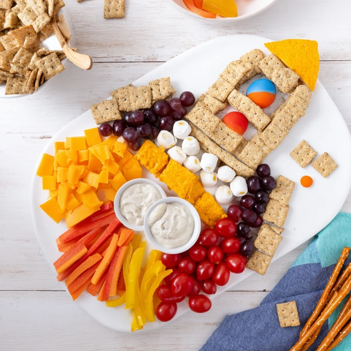 Blast Off Spaceship Snack Board with colorful planets, cheese rockets, and veggie flames.
