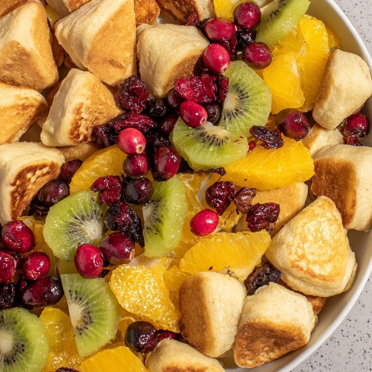 A gorgeous Brunch Board Bliss with assorted sweet treats, plus colorful, juicy fruits and syrup drizzling.