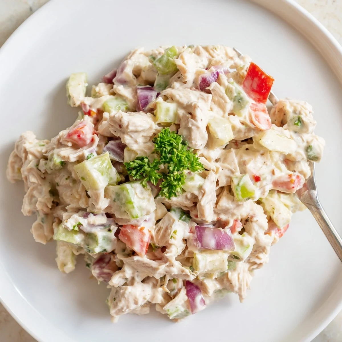 Creamy canned chicken salad with vibrant red peppers, seasoned with Mrs. Dash, ready to eat.