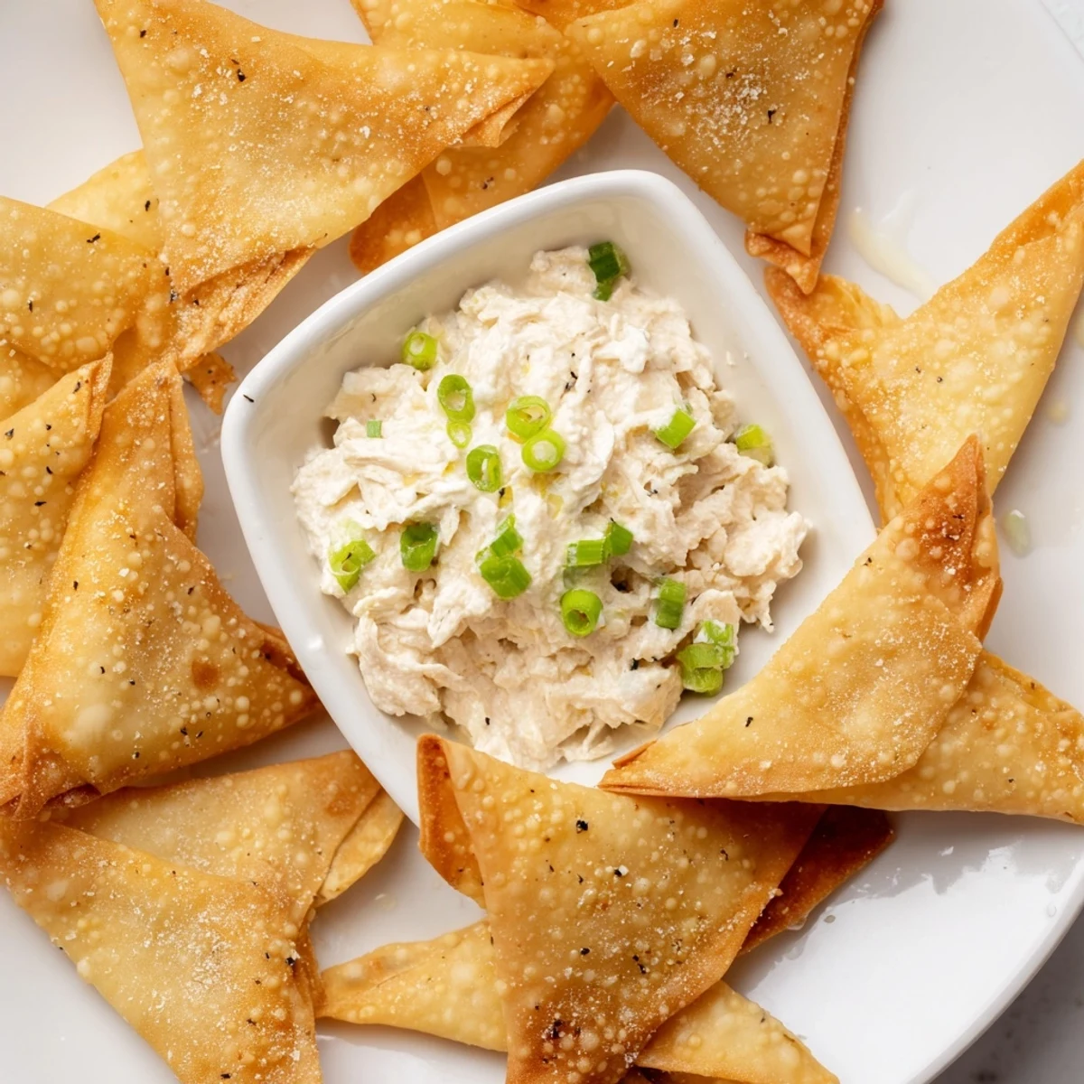 Freshly made Air Fryer Lumpia Chips with a flavorful chicken dip, perfect for sharing with friends and family.