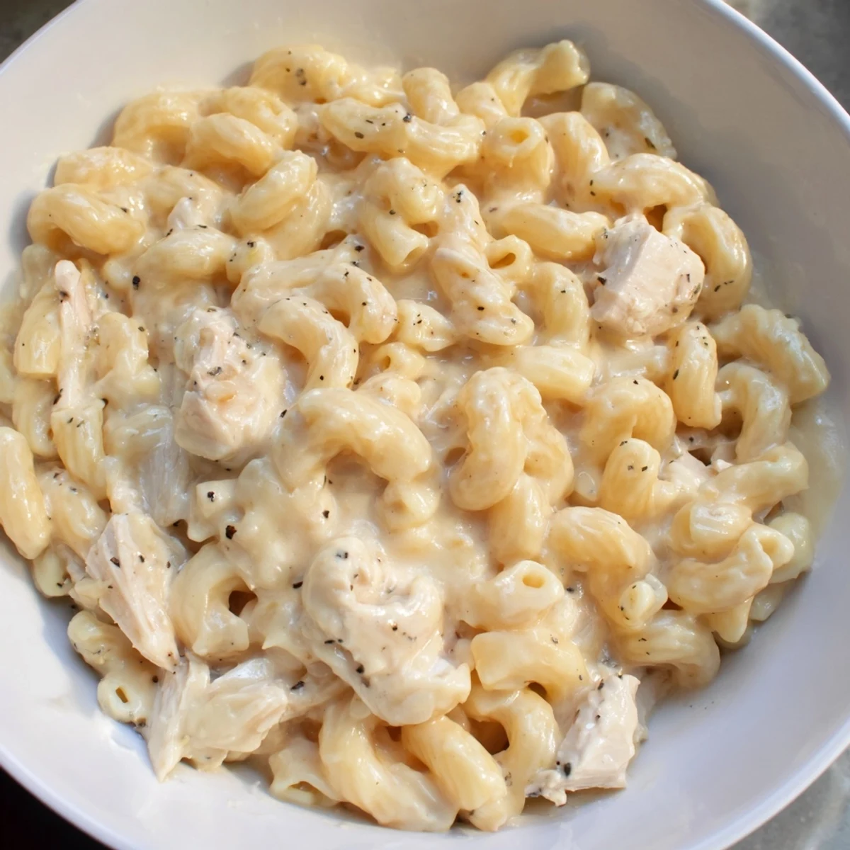 A close-up of generously portioned Struggle Meal Chicken Macaroni, steaming from the oven, ready to eat.