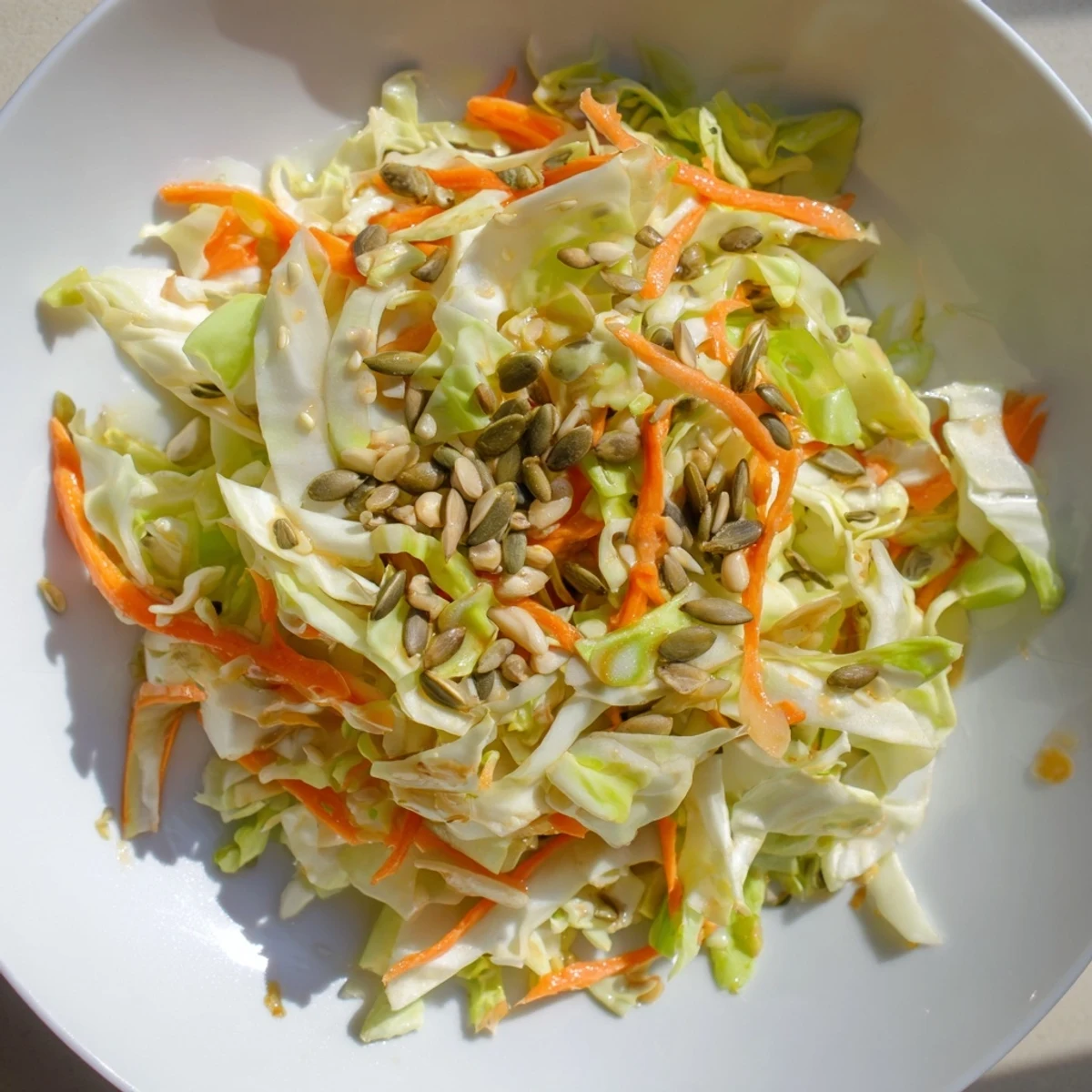 Crunchy cabbage-core slaw salad, a colorful mix of textures with sesame seeds and vibrant dressing.