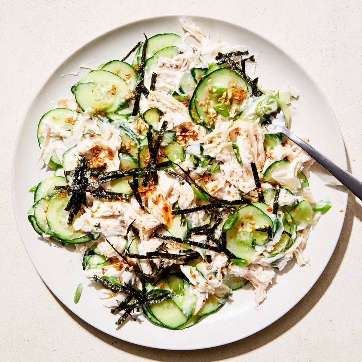 Fresh California Roll Cucumber Salad with creamy mayo dressing, shredded imitation crab, and crisp sesame-topped cucumber slices.