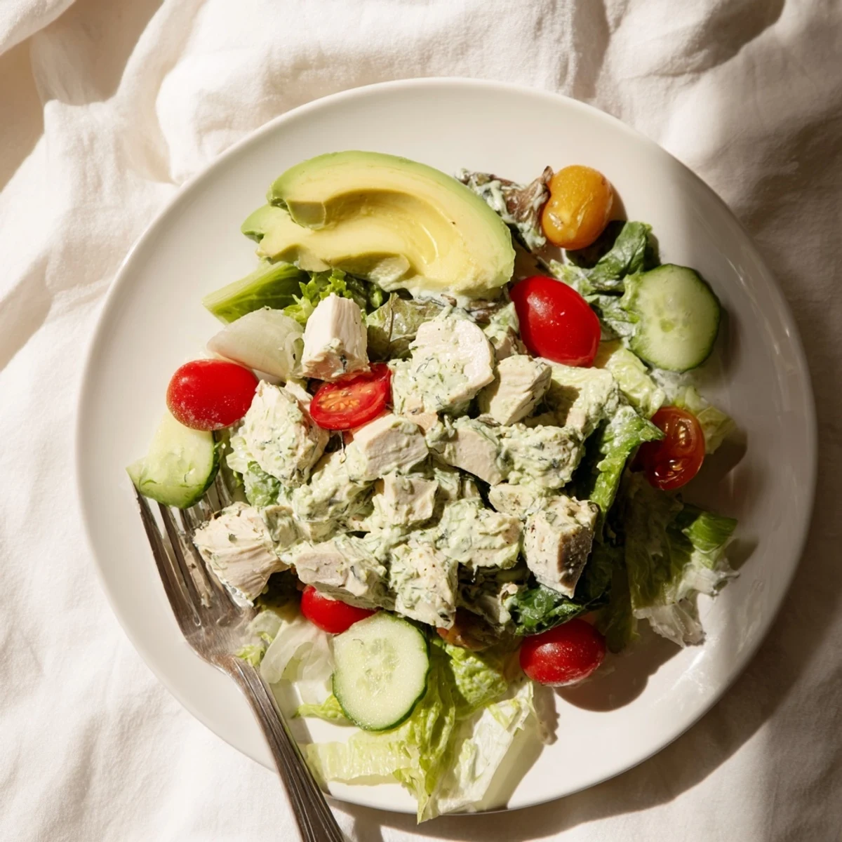 Ready-to-serve Green Goddess Chicken Salad with juicy chicken, fresh herbs, and colorful veggies on a platter, perfect for a light lunch.