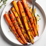 Oven-roasted Maple Glazed Roasted Carrots and Parsnips glistening, an easy vegetarian side dish.