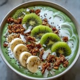 Shamrock Green Smoothie Bowl with Kiwi and Spinach topped with kiwi slices, granola, and coconut for a vibrant, healthy breakfast.  