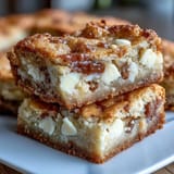 Decadent British-inspired cookie bars featuring clotted cream and creamy white chocolate chunks, baked to golden perfection.