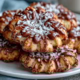 Delicate flower-shaped shortbread cookies with golden edges, perfect for spring celebrations and afternoon tea.