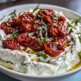 Creamy whipped feta blended with cream cheese and lemon, served with caramelized roasted cherry tomatoes and a drizzle of olive oil.  