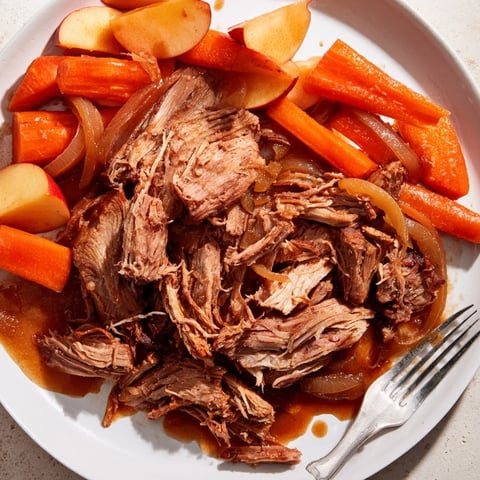 Slow Cooker Apple Cider Pork Roast served with caramelized apples and root vegetables.  