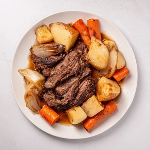 Tender Sunday Pot Roast with vividly roasted vegetables, perfect for a hearty family dinner.