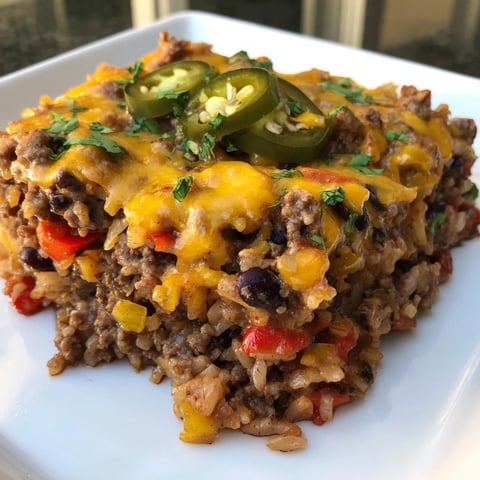 Steaming Tex-Mex Beef & Rice Casserole with melted cheese, perfect for a cozy weeknight meal.