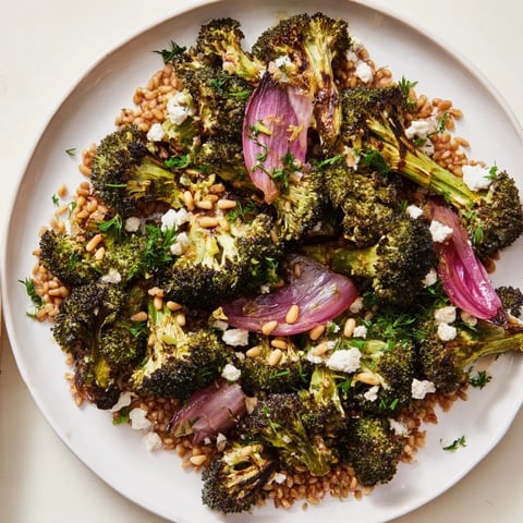 Warm roasted broccoli with garlic-lemon & farro, a vibrant image of a plated Mediterranean meal.