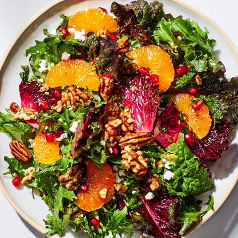 Winter Greens Salad: A colorful mix with citrus and pomegranate, topped with toasted nuts.