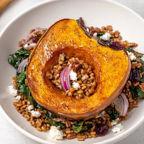 Golden acorn squash slices top this Farro & Mustard Green Salad, a colorful, hearty meal.
