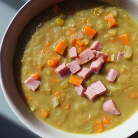 Steaming bowl of Hearty Split Pea and Ham Soup, garnished, ready to warm you on a cold day.