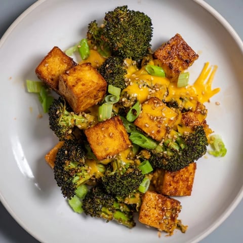 Golden-brown Cheesy Baked Tofu and Broccoli, smothered in sesame ginger sauce, is ready to serve.