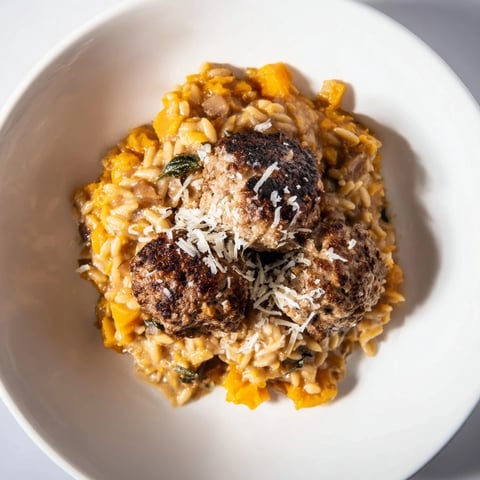 Warm, savory plate of sage turkey meatballs with pumpkin orzo, ready to enjoy.