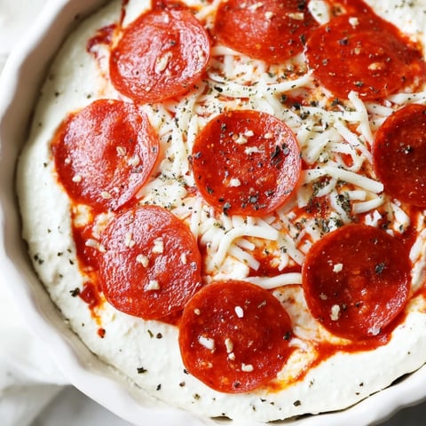 Pizza Dip bubbling with melted mozzarella and pepperoni, ready for scooping with crusty bread.