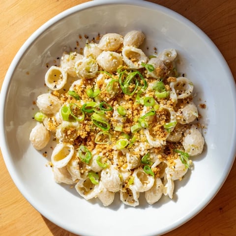 Creamy miso ditalini pasta, coated in a rich sauce and topped with fresh scallions and sesame seeds.