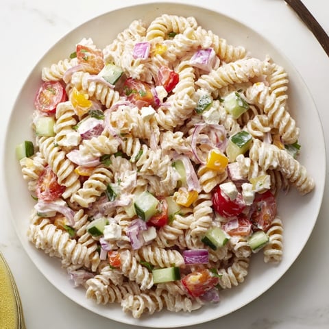Greek Yogurt Million Dollar Christmas Pasta Salad, a festive vegetarian dish with colorful, fresh vegetables.