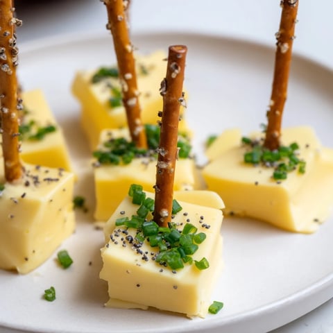 Festive photo: Cheddar Cubes and Pretzel Stick Sparklers with colorful garnish, ready to enjoy.