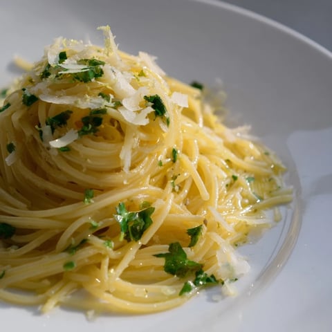 A close-up of Lemon Capellini with fresh herbs, a vibrant and zesty pasta dish.