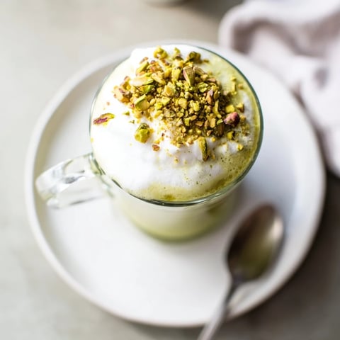 Steaming pistachio milk layered with espresso and fluffy cold foam in this Pistachio Latte.