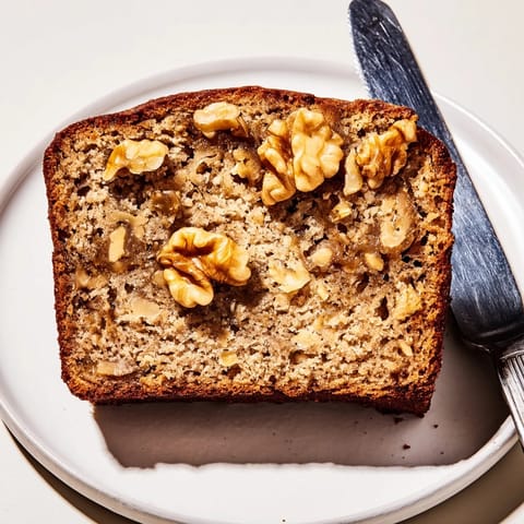 Homemade classic banana bread with crunchy walnuts, warm from the oven.  