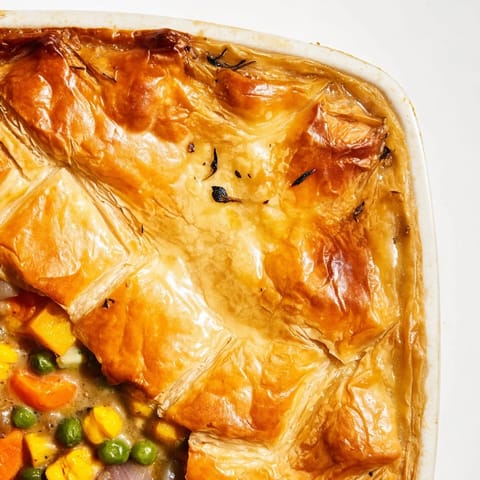 Hearty harvest vegetable pot pie served warm, featuring rich filling and flaky crust.  