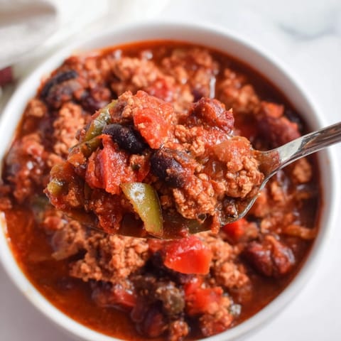 Hearty slow cooker turkey chili garnished with avocado and cilantro for added flavor.  