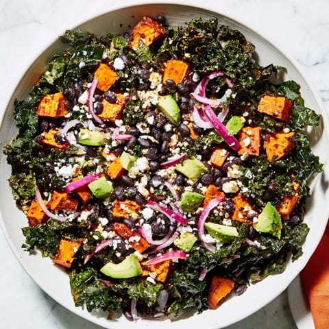 This healthy Massaged Kale Salad features roasted sweet potatoes, black beans, and a vibrant lime dressing.