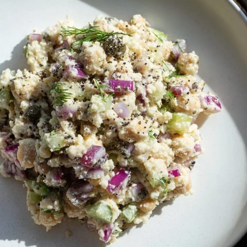 Chunky chickpea tuna salad, mixed with diced veggies and a tangy dressing, a satisfying lunch option.