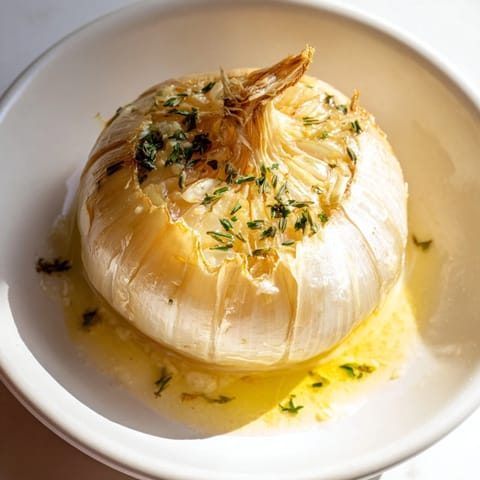 Savory, herb-infused steam envelops the juicy Onion Boil, ready to be enjoyed with crusty bread.