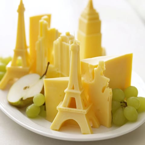 Enjoy a visually striking Skyline Silhouette featuring various cheeses, fruits, and crackers perfect for a party.