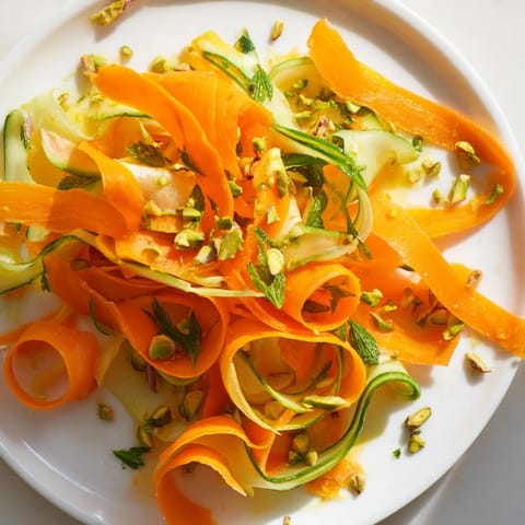 Enjoy a refreshing plate of Citrus Carrot Ribbon Salad, tossed with citrus and pistachios.