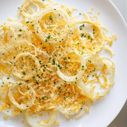 Melted cheese coats crispy onion slices in this savory, air-fried recipe.