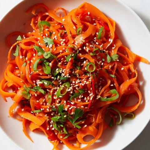 This easy vegan Carrot Ribbon Salad Asian-Style is tossed with fresh green onions and cilantro for a bright, refreshing crunch.  