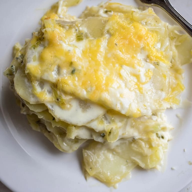 Tender potato layers smothered in a rich cheese sauce, ideal for family dinners.  