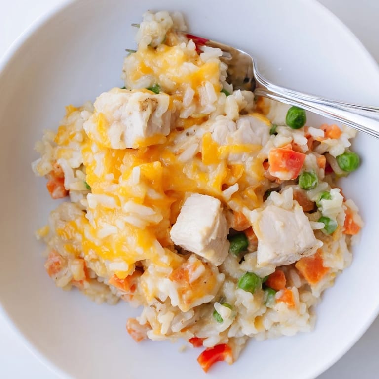 Delicious One-Pot Cheesy Chicken and Rice, a perfect family meal with tender chicken and fluffy rice.