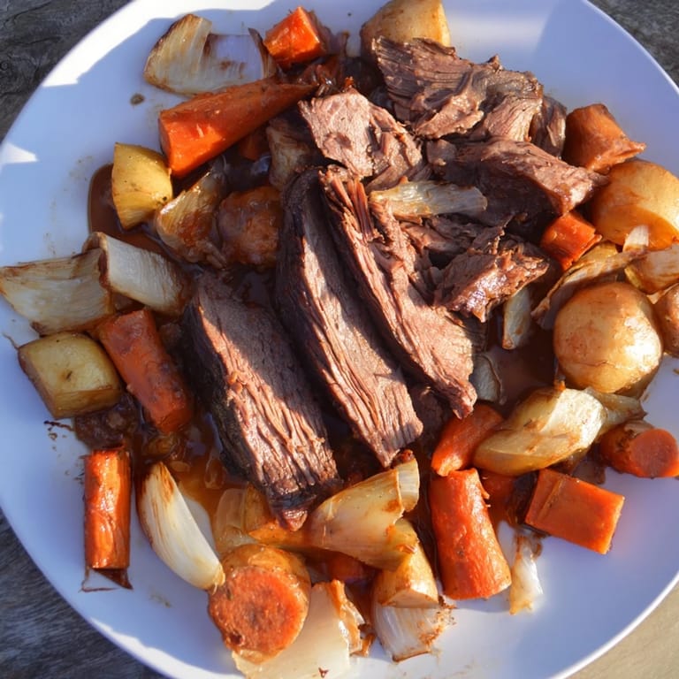 Close-up of a steaming Sunday Pot Roast, showcasing juicy beef and colorful, roasted veggies.