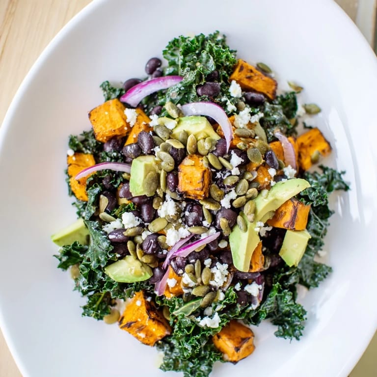 Enjoy a delicious serving of Massaged Kale Salad with pumpkin seeds, a perfect vegetarian meal.