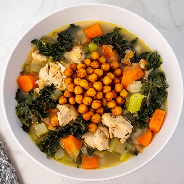 Savory Chicken Kale Soup with a delightful topping of spiced, crunchy chickpeas, perfect for dinner.