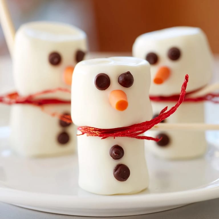 Festive Express Snowman Marshmallow Pops, adorned with dark chocolate faces and colorful scarves.